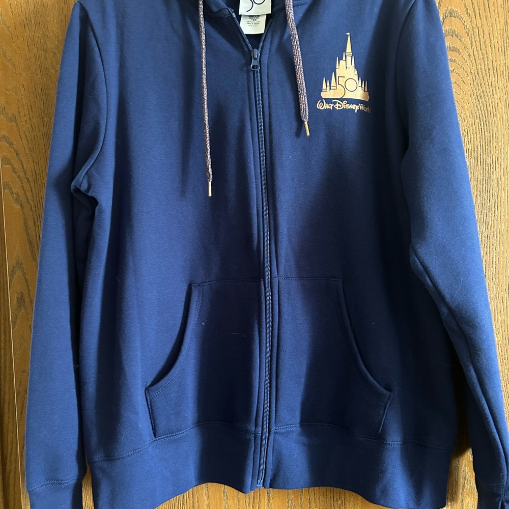 Disney 50th Anniversary blue zip with hood. Bought at Disney and never worn.
